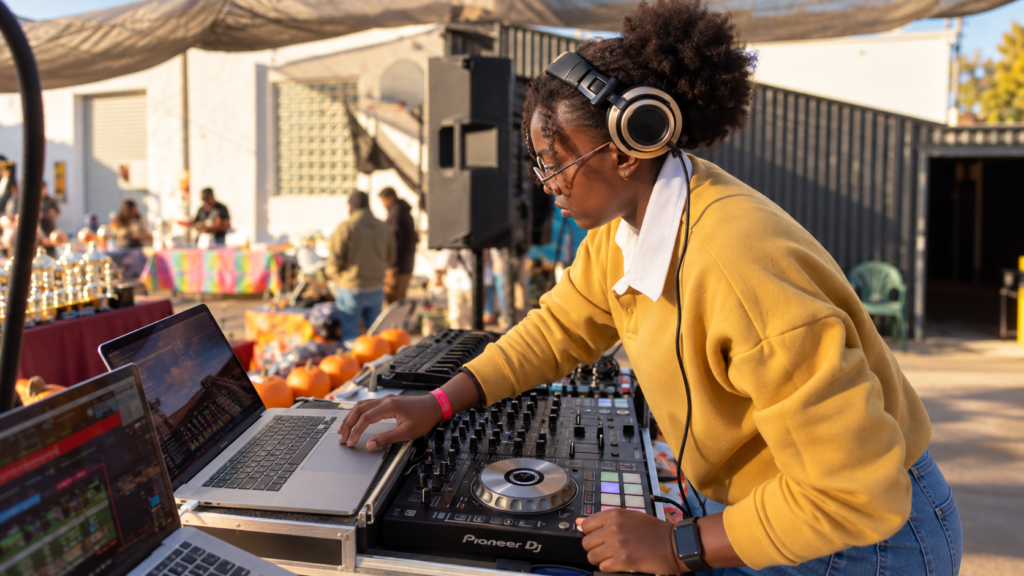 DJ J Carbon mixing on a Pioneer DJ controller at an outdoor event
