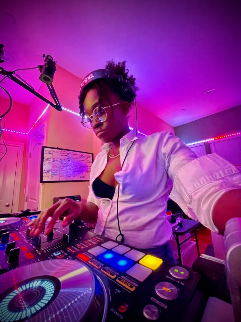 DJ J Carbon in her home studio with headphones on